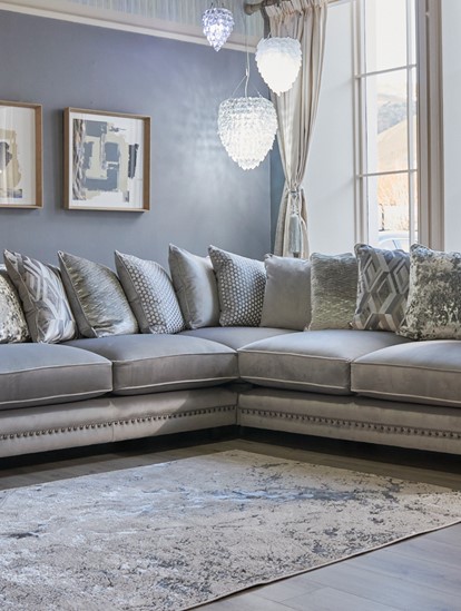 Luxurious grey velvet corner sofa in a stylish living room