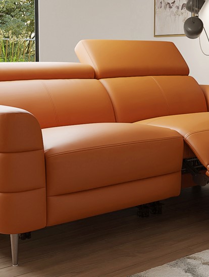 A tan brown leather recliner sofa shown in a contemporary living room