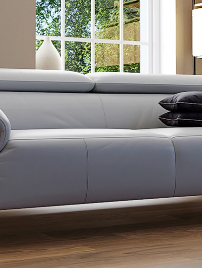 A light coloured Italian leather sofa with metal legs in a modern living room
